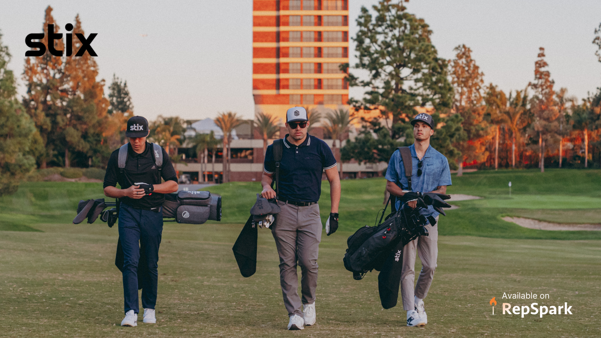 Three young adult males walking together on a golf course in the evening with their Stix Golf bags.